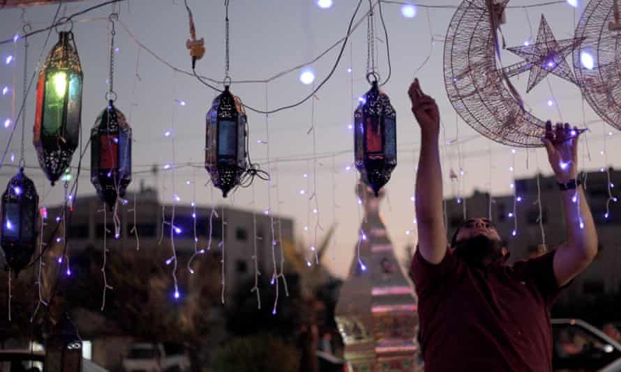 A street vendor plugs in decorations for Ramadan in Amman, Jordan.