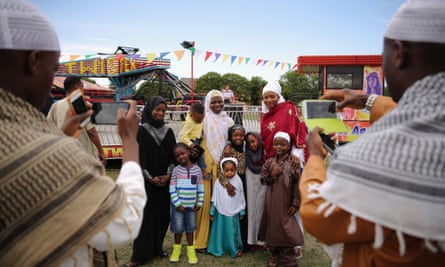 A family has their photograph taken after morning prayers during an Eid celebration in Burgess Park, south London.