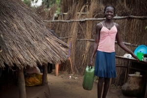Angae Nugwo, who is 15,  poses for a photograph and does her household chores, like collecting water,  as part of a UNICEF photo project to show Girls Empowerment in the village of Itang, near Gambella,  Ethiopia Friday, Feb. 27, 2015. "Our father died and I want to stay with my mother and become a nurse here so I can help my community with health care"  she says.
