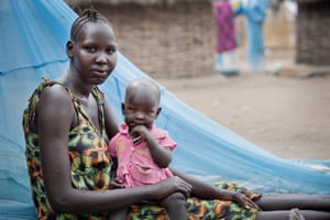 Nyabuay Bol, 17 years old, and who has 2 children ages 3 years old and 10 months poses for a photograph with her youngest child at her home in Itang, Gambella, Ethiopia Friday, Feb. 27, 2015. She says: "When I got married and moved to this village, I could have gone to the 9th grade but my husband would not let me attend school after we got married" The project aims to document the hopes, dreams and aspirations of Ethiopian girls in different parts of the country.
