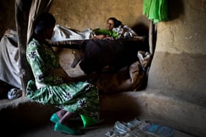 Gurdo Shenqut, 14 years old, lies in bed after giving birth to her first child in her mothers house in the vvillage of Addis Ge, near Fiche, Ethiopia Saturday, Feb. 21, 2015. Gurdo was married at the age of 11 to a man she hardly knew, and was forced to give up school, He is unable to look after her and their new baby properly as he is too poor so she is staying with her mother. She is also increasingly scared of him becuase he beats her when he gets angry.