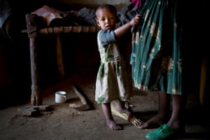 A young girl clings onto her mothers skirt in their home  in the village of Addis Ge, near Fiche, Ethiopia Saturday, Feb. 21, 2015.