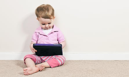 Young girl playing on a tablet computer.