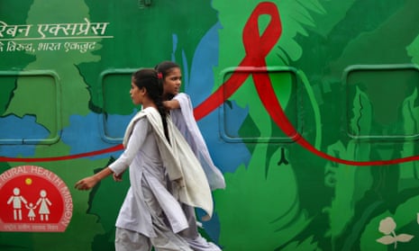Students in Calcutta walk past the Red Ribbon Express, a train used for an HIV/Aids awareness campaign in India.