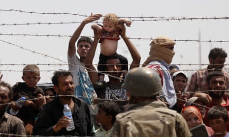 Syrian refugees trying to cross the border into Turkey.