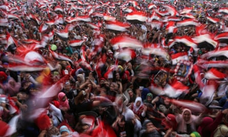 Egyptians wave national flags at a celebration in Cairo’s Tahrir Square on 3 June 2014.