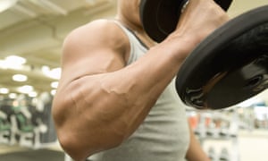Man lifting dumbbell in gym