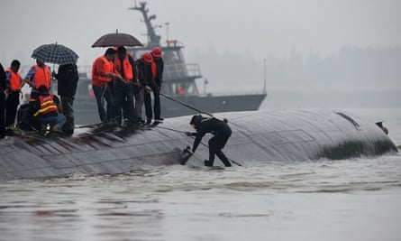 Rescuers work on the overturned passenger ship in the Jianli section of the Yangtze River.