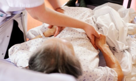 Older person being cared for by a nurse.