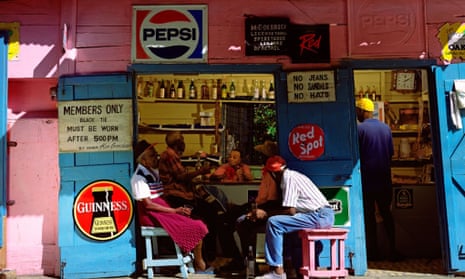 Rum Shack Bar in West Indies, Guinness and pepsi logos are shown and four men are sat chatting