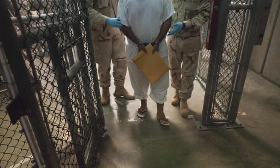 US military guards move a detainee inside Camp VI at Guantanamo Bay, Cuba in 2010.