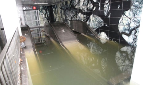 Escalators to the South Ferry Whitehall St. subway station in the financial district of Manhattan are shown flooded in the aftermath of Hurricane Sandy.  A new study finds that without human-caused global warming, the New York subways might not have been flooded.