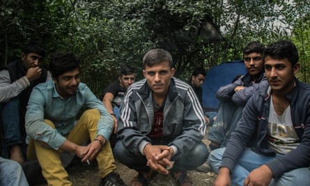 A group of Afghan migrants gather at a makeshift camp awaiting people smugglers or money to move northwards through Hungary.