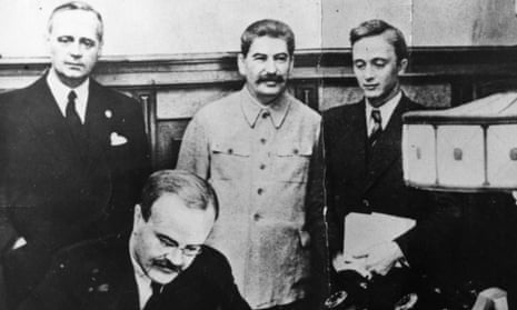 23rd August 1939: Vyacheslav Mikhaylovich Molotov, Russian Foreign Minister, signs the non-aggression pact negotiated between Soviet Russia and Germany. Standing behind him is his German counterpart Joachim von Ribbentrop (left), and Joseph Stalin (centre).