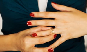 Woman taking off wedding ring