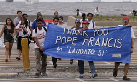 Environmental activists march towards a Roman Catholic church