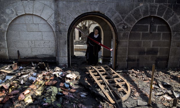 A nun at the Church of Multiplication which was badly damaged in a fire on Thursday.
