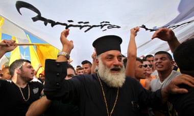 Palestinian Christians in Israel take part in a protest near the Church of the Multiplication, after the suspected arson attack.
