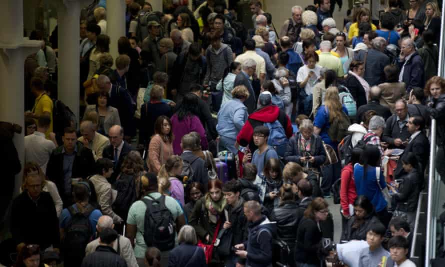 Eurostar passengers wait stranded as Eurostar trains are canceled at St Pancras station in London.