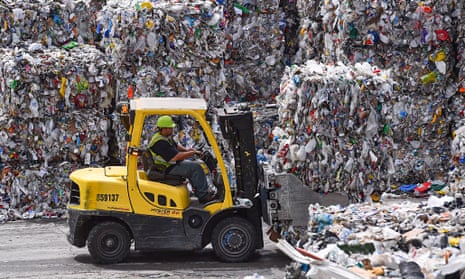 A forklift operator stacks bales of recyclables at Waste Management’s facility in Elkridge, Md. 
