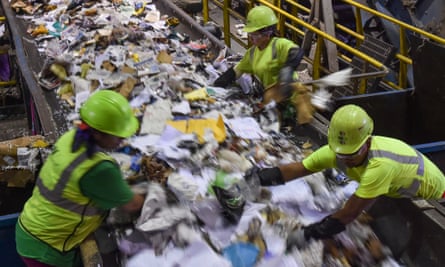 Workers sort waste at the Waste Management's Elkridge Material Recycling Facility
