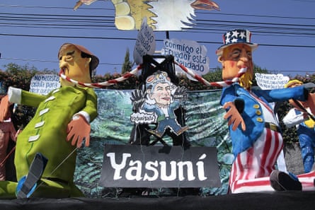 Dolls representing the oil exploitation in the Yasuni zone are paraded in Quito 