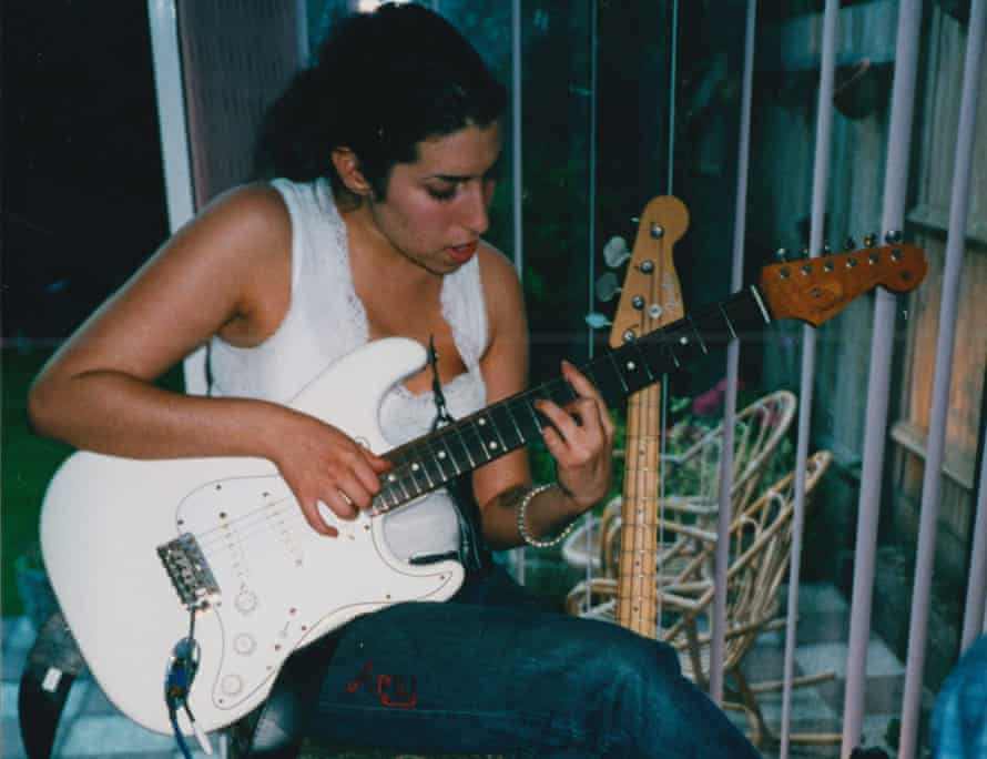 Back in white: a young Winehouse plays at home.