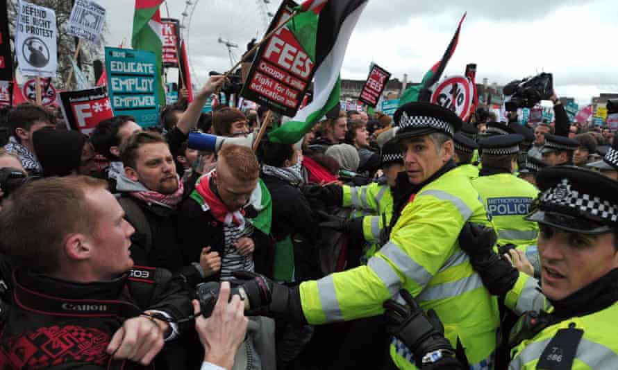 Protesters scuffle with police during a student rally in central London, in 2012, against rises in university tuition fees.