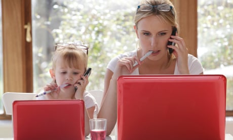 Daughter and mother using their mobile phone and looking at their laptop