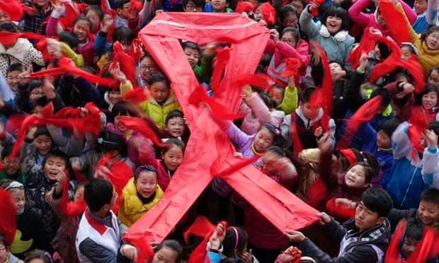 Pupils and students hold a giant red ribbon during an event to raise awareness of HIV/Aids on the World AIDS Day, in Fuyang, Anhui province China in 2014.
