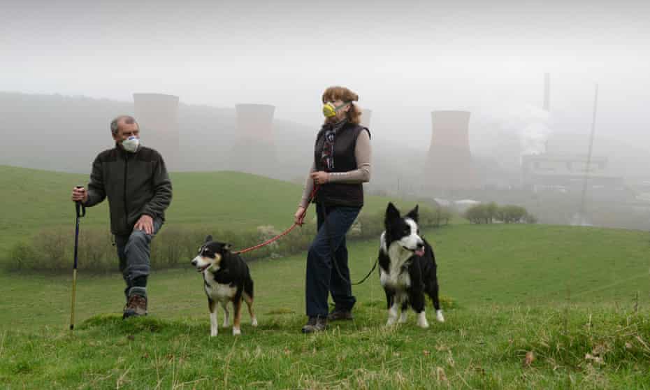 Walkers wearing smog masks near Ironbridge power station as the pollution moved westwards