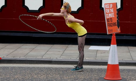 A anti-fracking protester plays with a hula hoop during a demonstration outside County Hall in Preston.
