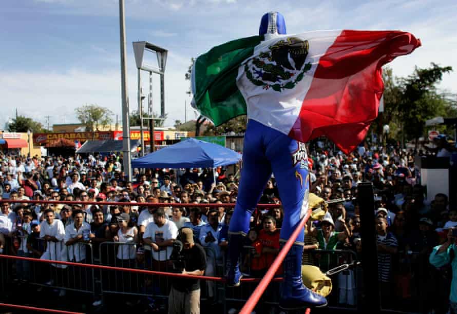 Lucha Libre Star Blue Demon Jr waves the Mexican flag after winning a wrestling match in Miami.