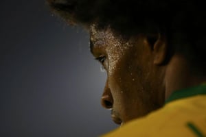 In Santiago, Brazil's Willian pauses during the Copa América match against Venezuela at Estadio Monumental David Arellano. Thiago Silva and Roberto Firmino scored early in each half to fire Brazil to a 2-1 win.