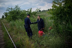 A Serbian border police officer finds a group of illegal immigrants from Syria near a railway close to the border with Hungary. Hungary said it had indefinitely suspended the application of a key European Union asylum rule in order to ‘protect Hungarian interests’. Illegal immigrants cross Serbia on their way to other European countries as it has land access to three members of the 28-nation EU: Romania, Hungary and Croatia. The number of immigrants entering Hungary rose from 2,000 in 2012 to 54,000 this year.