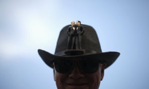 A man wears a hat with two grooms on the front at a celebration rally in West Hollywood, California