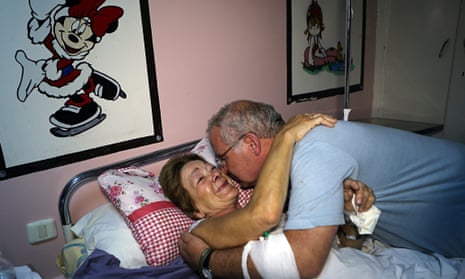 Cris Callaghan hugs her husband in a hospital in Sousse