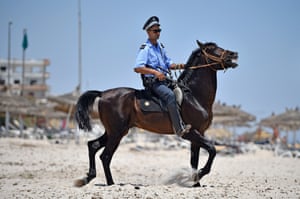 Armed police on horseback patrol Marhaba beach in Sousse, Tunisia