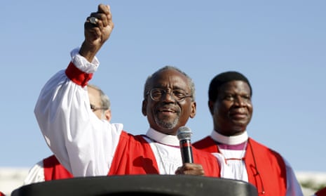 Bishop Michael Curry, along with approximately 60 Episcopal bishops, lead hundreds of marchers through the streets to protest gun violence as part of their convention in Salt Lake City, Utah, Sunday.
