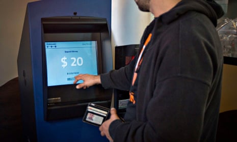 A customer uses the world's first ever permanent bitcoin ATM unveiled at a coffee shop in Vancouver, British Columbia 29 October, 2013. <a href="http://www.coinfox.info/news/2256-greek-bitcoin-enthusiasts-installed-first-bitcoin-atm-in-athens">A similar model was launched in Athens on 22 June, 2015</a>.