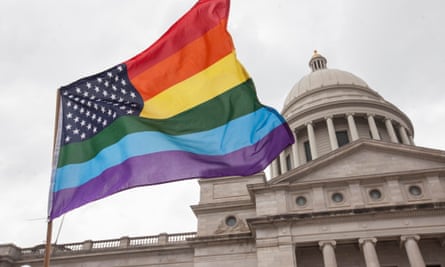 A rainbow flag flies over the crowd during a press conference by the Human Rights Campaign on the steps of the Arkansas State Capital in Little Rock following Gov. Asa Hutchinson's comments on House Bill 1228, a bill passed which prohibits state and local governments from infringing on a person's religious beliefs without a "compelling" interest,