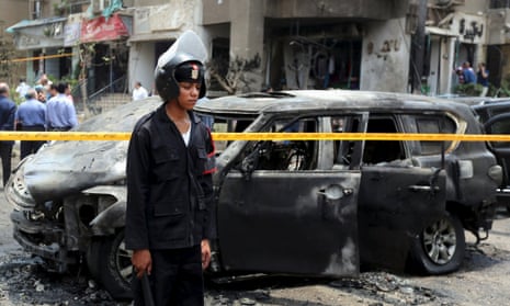 Police investigate the site of a car bomb attack on the convoy of Egyptian public prosecutor Hisham Barakat