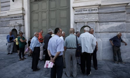 People wait outside a closed National Bank of Greece branch in Athens.