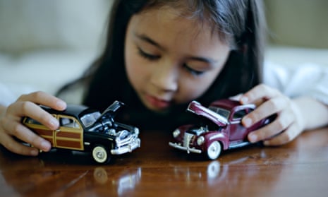Girl playing with toy cars