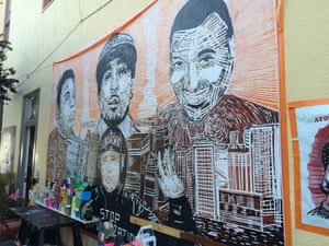 Amilcar Perez-Lopez with his hands up on a mural, which also includes Eric Garner and Michael Brown. Photograph: Oliver Laughland for the Guardian