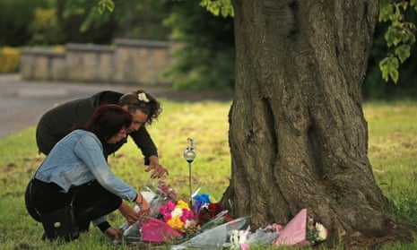 People lay flowers at the scene in Westfield Lane, Mansfield, where the body of missing girl Amber Peat was found.