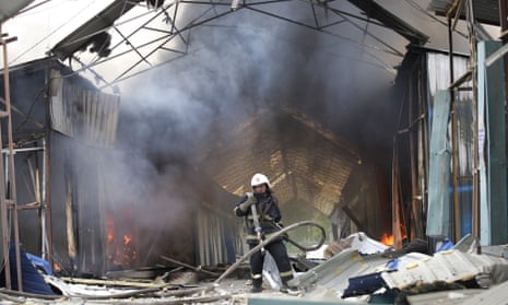 A firefighter extinguishes the fire at a market destroyed after shelling in Donetsk, Ukraine on Wednesday.