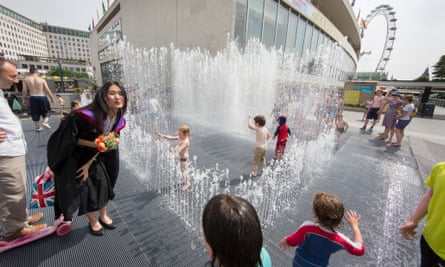 Children and their parents play in the fountains at the Southbank Centre, outside the Royal Festival Hall