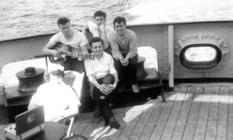 New York-bound: Bill Harrison (with guitar) with crewmates on RMS Corinthia in 1960. The reel-to-reel tape recorder (front left) was used as a PA system in the ship's crew bar, the Pig and Whistle.