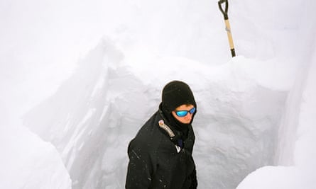 Philip de Roo digs into the ice in Greenland